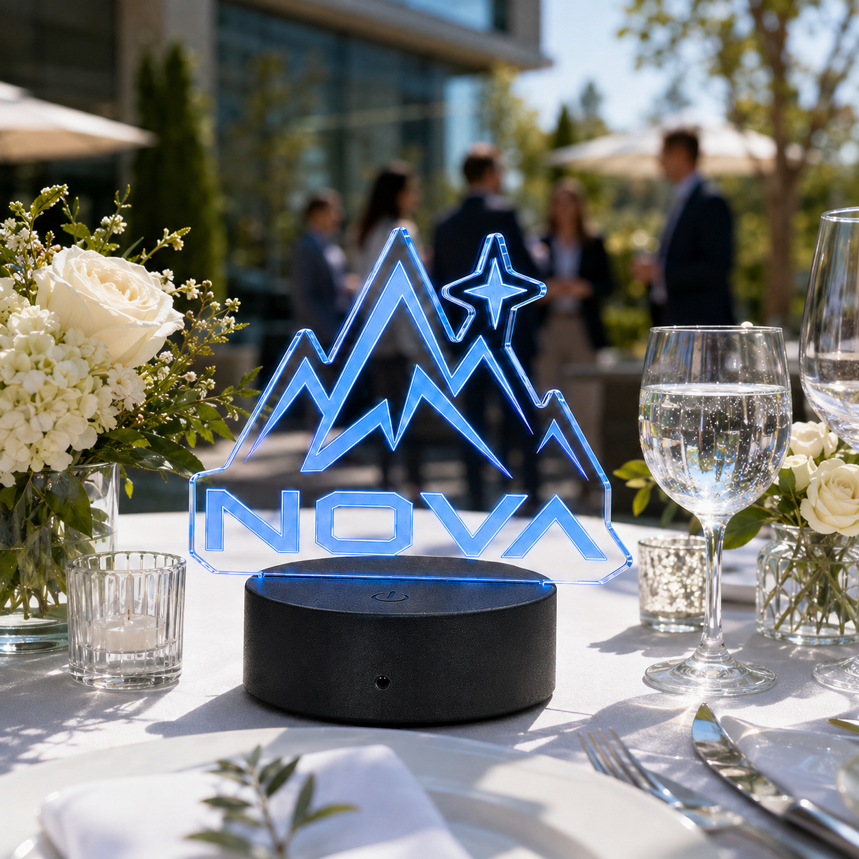 Custom clear die-cut LED acrylic business logo sign at a daytime corporate event