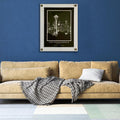White floating acrylic picture frame holding a botanical print on a navy blue living room wall